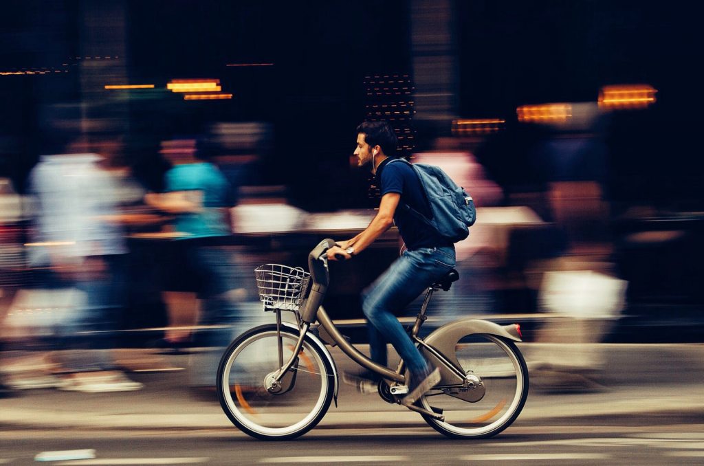 man riding electric bike with blurred background