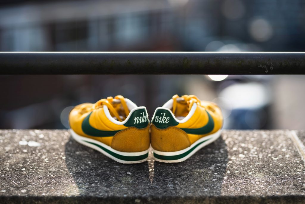 yellow nike cortez shoes overlooking city