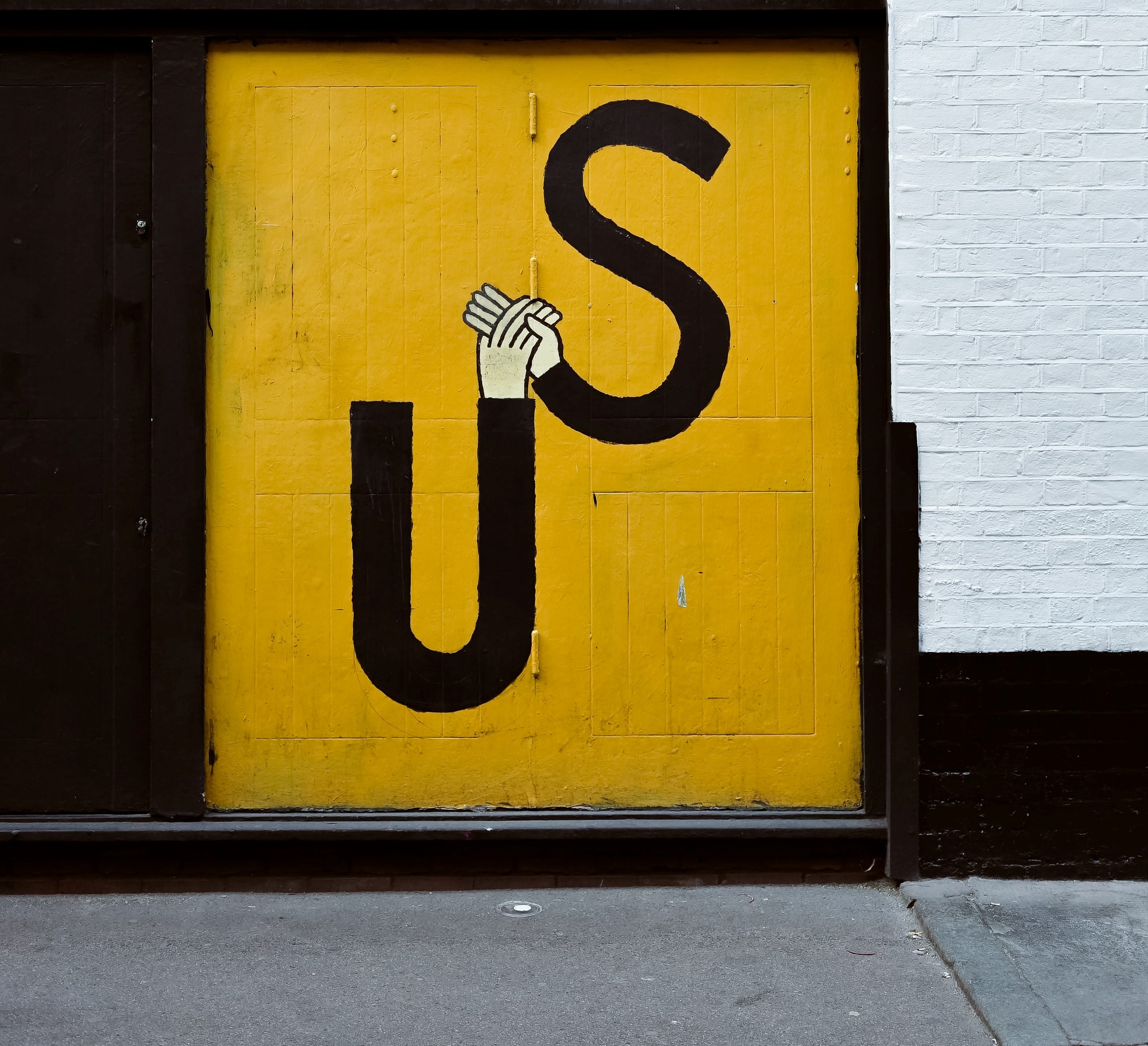 Yellow door with US Graffiti on it