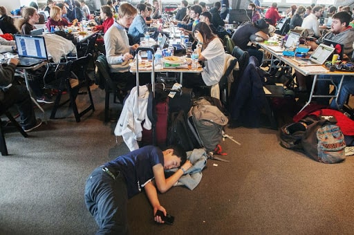 people working and sleeping during a hackathon